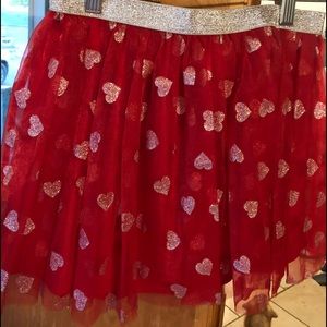 Girl’s red skirt with silver hearts